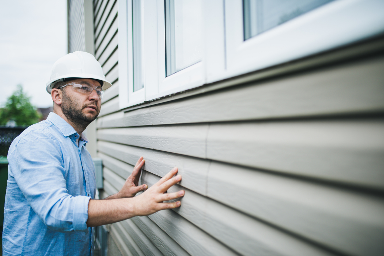 Building inspector checking the windows of a residential building